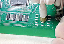 Figure 3. Board at angle while cleaning chips, and wipe placed under the board.